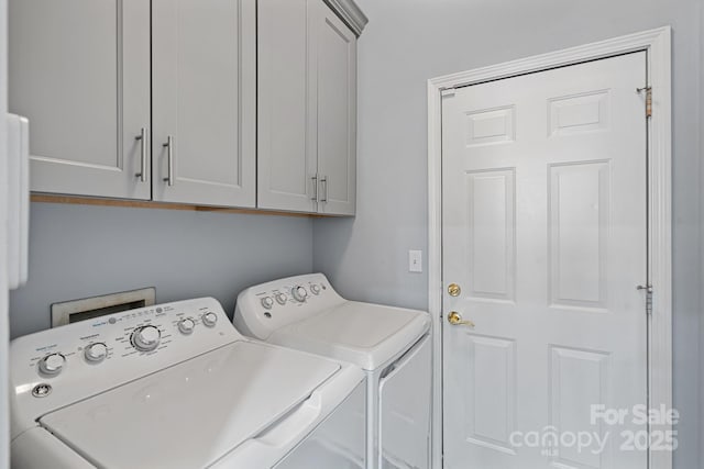 laundry room with cabinet space and washer and dryer