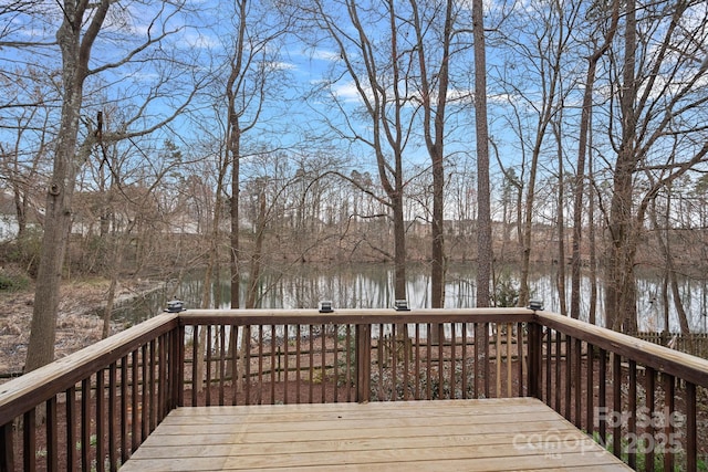 wooden deck featuring a water view