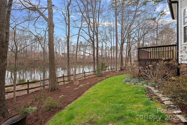 view of yard with a water view and fence