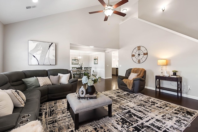 living room featuring visible vents, a ceiling fan, wood finished floors, high vaulted ceiling, and baseboards