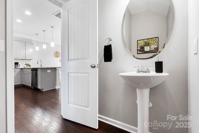 bathroom with baseboards, tasteful backsplash, recessed lighting, and wood finished floors