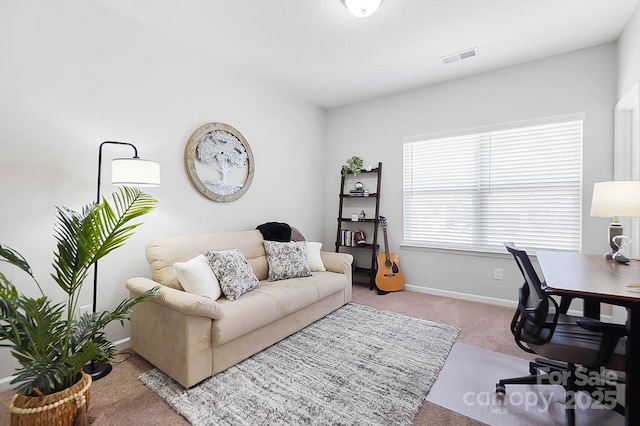 home office featuring baseboards, carpet flooring, and visible vents