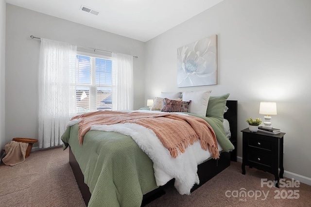 carpeted bedroom with baseboards and visible vents