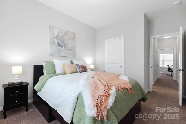 carpeted bedroom featuring baseboards