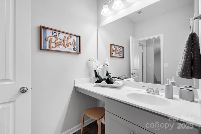 bathroom with visible vents, wood finished floors, and vanity