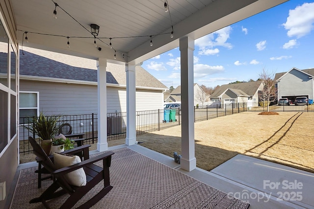 view of patio / terrace with a fenced backyard and a residential view
