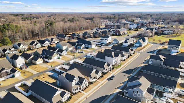 birds eye view of property with a residential view and a wooded view