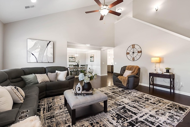 living area with high vaulted ceiling, ceiling fan, baseboards, and wood finished floors