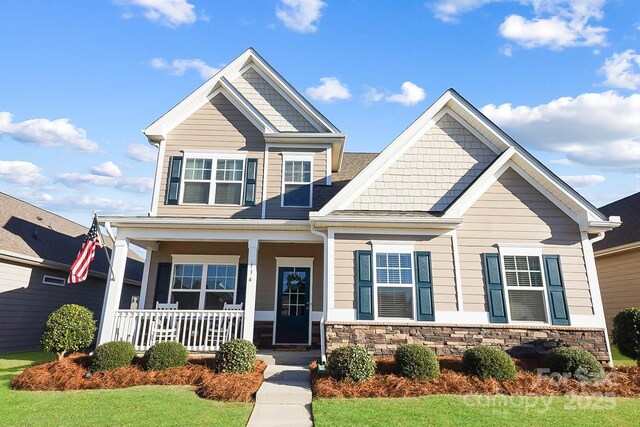 136 Kingston Dr, Locust, NC 28097 - craftsman house featuring covered porch and stone siding