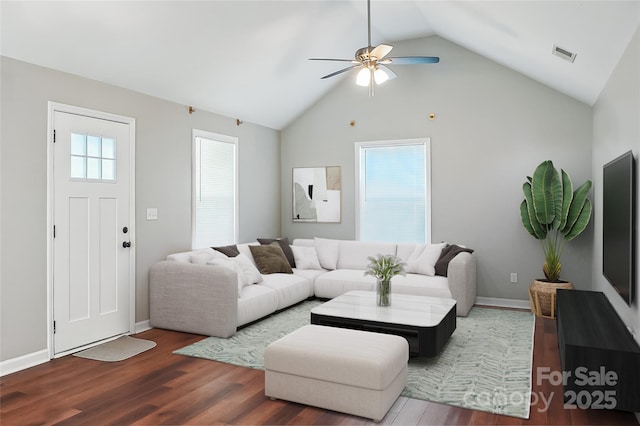 living room with lofted ceiling, visible vents, ceiling fan, wood finished floors, and baseboards