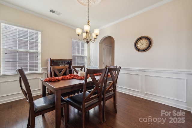 dining area with dark wood-type flooring, visible vents, plenty of natural light, and an inviting chandelier