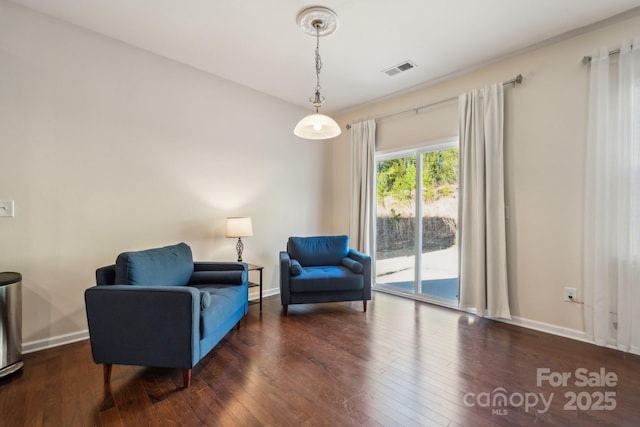 sitting room featuring wood-type flooring, visible vents, and baseboards