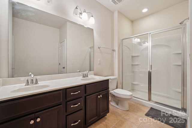 bathroom featuring a sink, a shower stall, and tile patterned floors