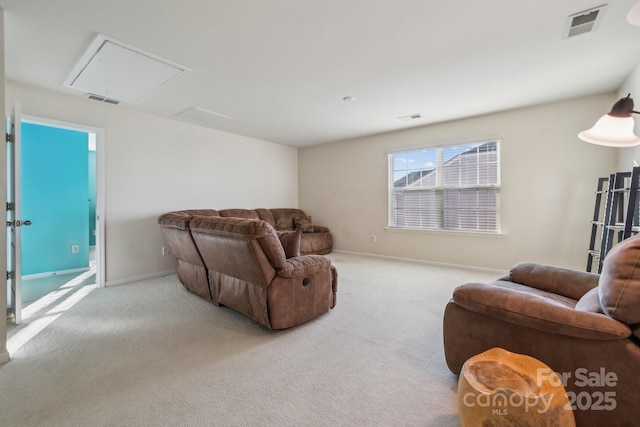 carpeted living room featuring visible vents and baseboards