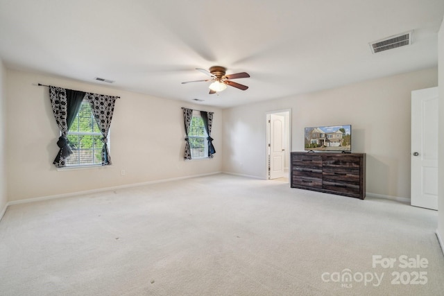 unfurnished bedroom featuring carpet floors, a ceiling fan, visible vents, and baseboards