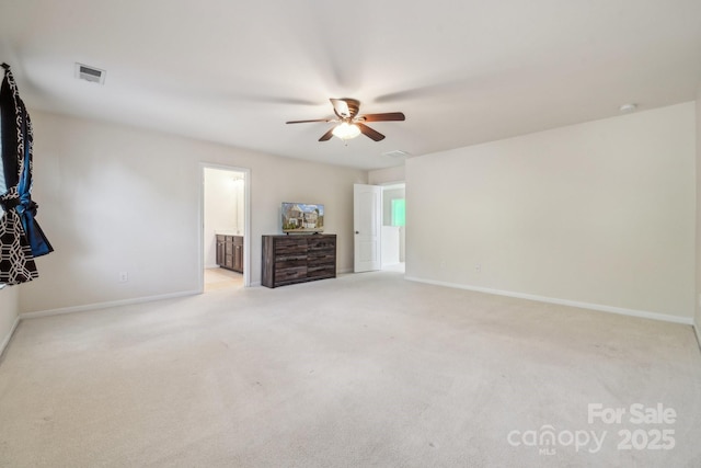 unfurnished bedroom featuring visible vents, baseboards, a ceiling fan, ensuite bath, and carpet