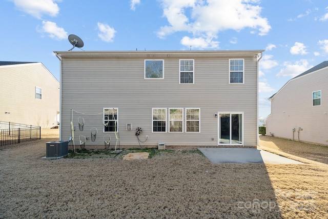 back of property featuring central AC, a yard, a patio area, and fence