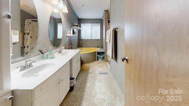 bathroom with double vanity, visible vents, a sink, and a bath