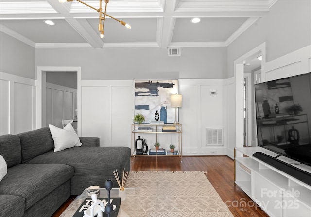 living room featuring visible vents, coffered ceiling, wood finished floors, and beamed ceiling