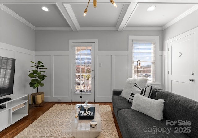 living room with dark wood-type flooring, beam ceiling, and a decorative wall