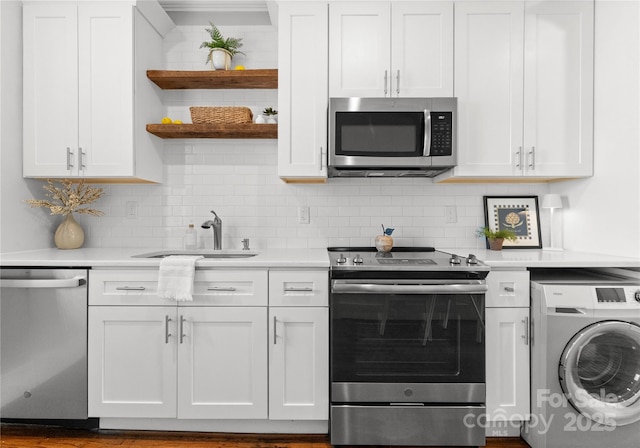 kitchen with appliances with stainless steel finishes, washer / clothes dryer, light countertops, and open shelves