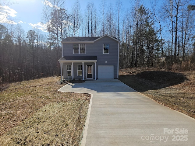 traditional-style home featuring driveway and an attached garage