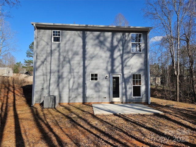 rear view of property with a patio and central air condition unit