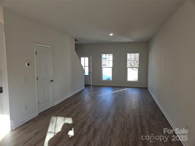 interior space with baseboards and dark wood finished floors