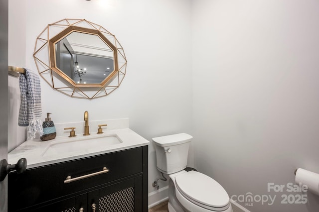 half bathroom with vanity and toilet