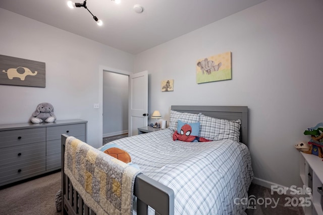 bedroom featuring carpet and baseboards