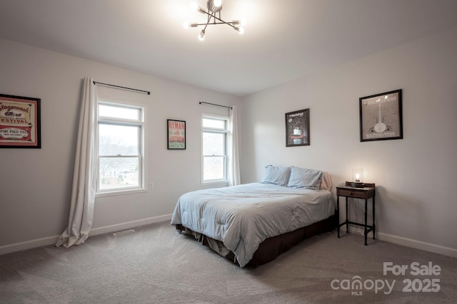 carpeted bedroom featuring baseboards