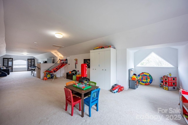 recreation room with carpet floors, lofted ceiling, and a wealth of natural light