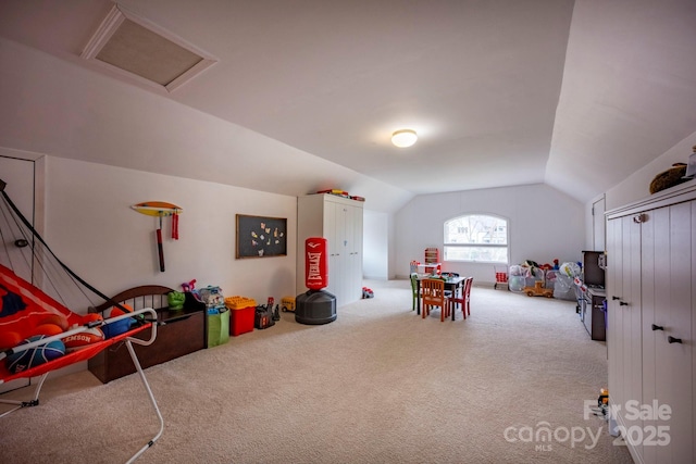 rec room featuring attic access, carpet flooring, and vaulted ceiling