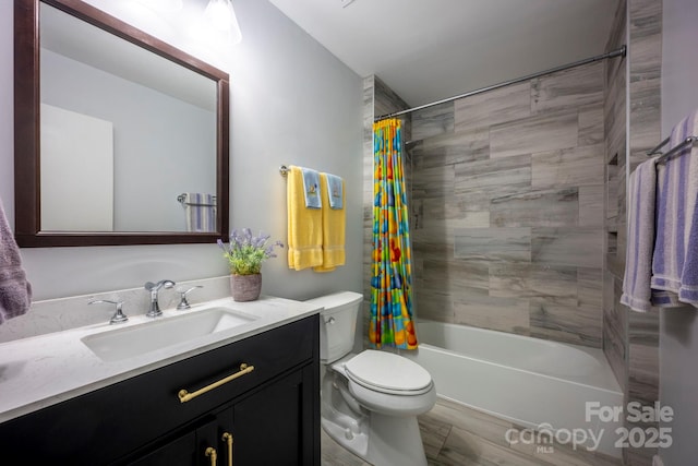 bathroom featuring toilet, shower / bath combo with shower curtain, and vanity