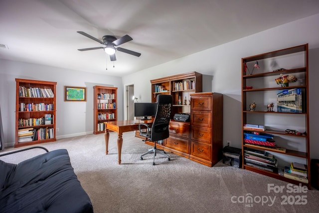 carpeted home office with visible vents, baseboards, and a ceiling fan