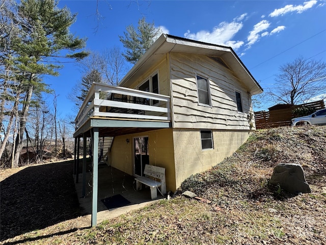 view of home's exterior featuring a patio and a wooden deck