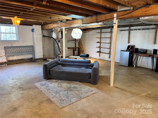 basement with heating unit and fridge