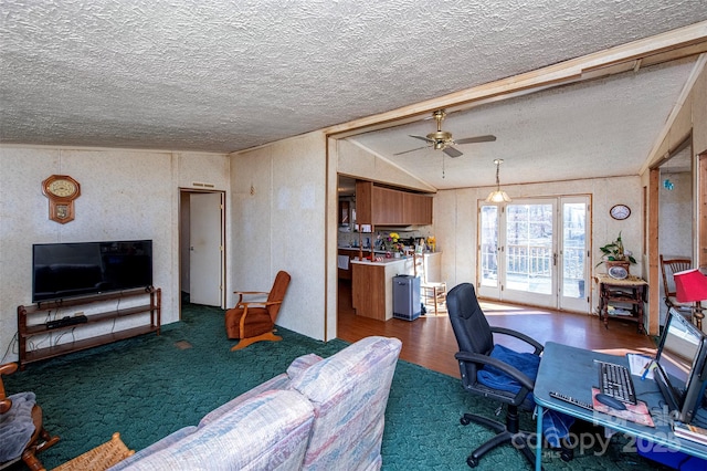 office area featuring lofted ceiling, a textured ceiling, carpet floors, and a ceiling fan