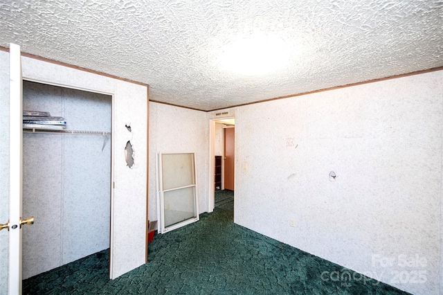 unfurnished bedroom featuring carpet, a closet, crown molding, and a textured ceiling