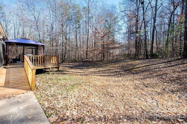 view of yard featuring a deck and a gazebo