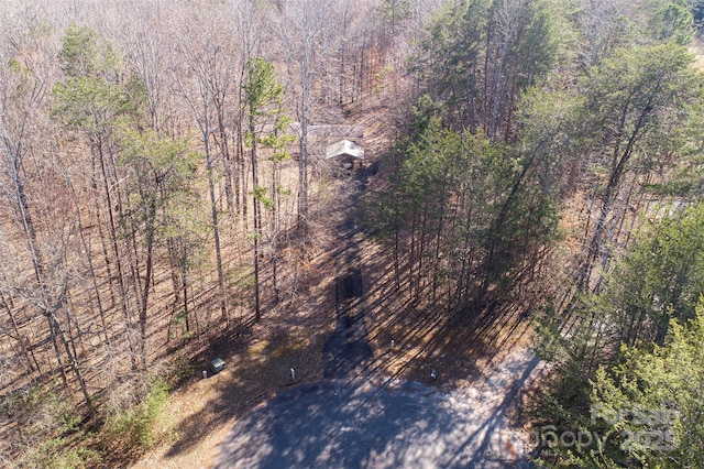 drone / aerial view with a wooded view