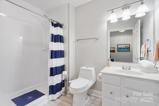 full bathroom with curtained shower, toilet, wood finished floors, and vanity