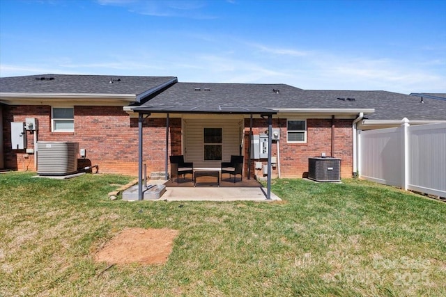 rear view of house featuring a patio area, fence, central AC unit, and brick siding