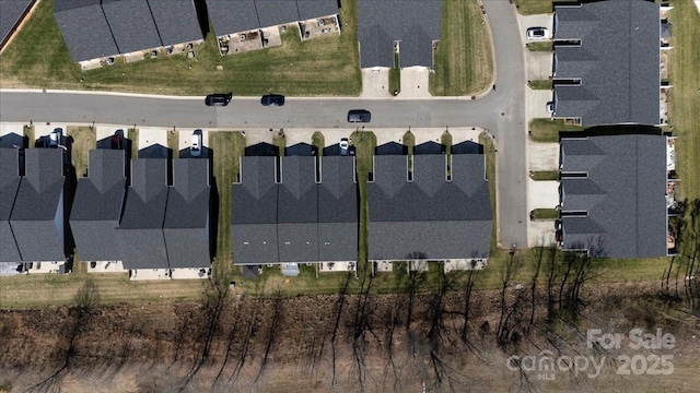 birds eye view of property with a residential view