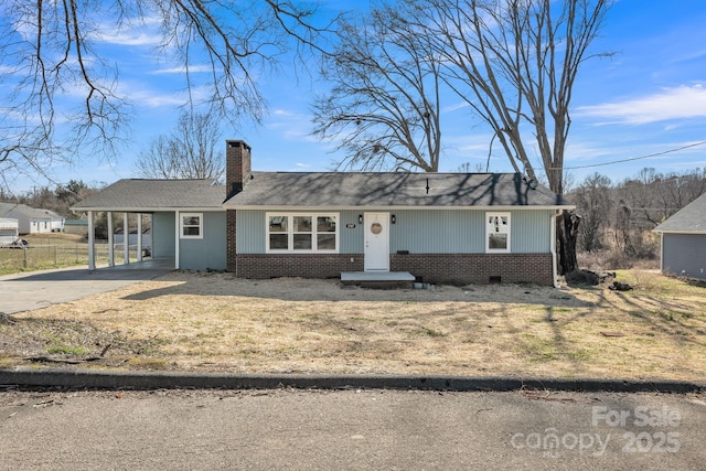 single story home featuring brick siding, a chimney, concrete driveway, crawl space, and an attached carport