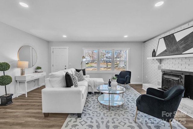 living area with dark wood-style floors, recessed lighting, a fireplace, and baseboards