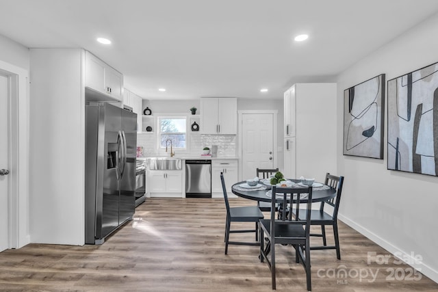 dining area featuring baseboards, recessed lighting, and light wood-style floors