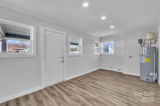 foyer featuring water heater, recessed lighting, baseboards, and light wood-style floors