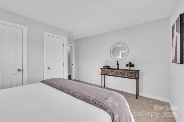 carpeted bedroom featuring baseboards