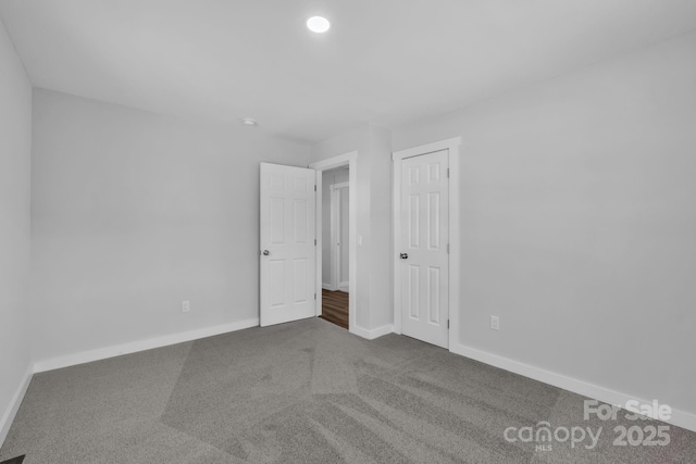 unfurnished bedroom featuring carpet floors, recessed lighting, and baseboards